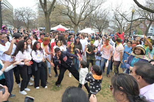 Gathered in the Square Park, Indian families grooved to music and embraced the spirit of Holi. Sharing moments of joy and laughter, they enjoyed the Indian cuisine and culture. (Image: X)