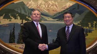 Chinese Vice Premier He Lifeng, right, shakes hands with U.S. Senator Steve Daines before a meeting held in the Xinjiang Room at the Great Hall of the People in Beijing, China, Saturday, March 22, 2025. (AP Photo/Ng Han Guan, Pool)