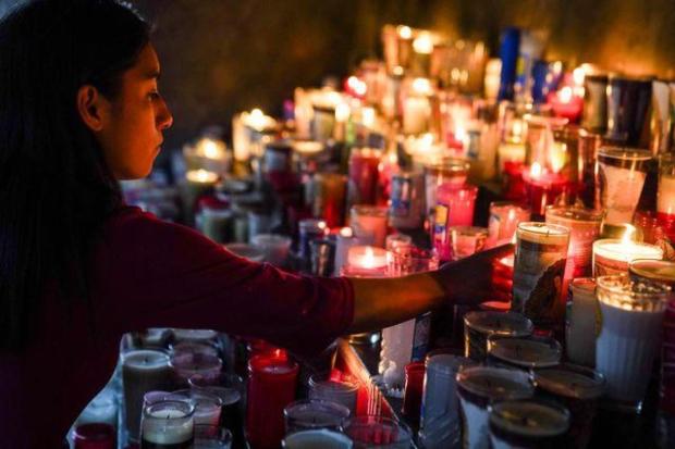 A woman lights a candle during Mass in memory of Pope Francis at the Basilica of Our Lady of Guadalupe, in Mexico City.