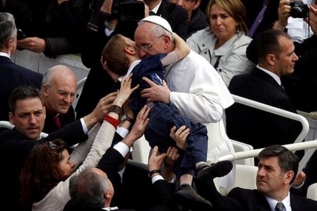 Pope Francis hugs 8-year-old Dominic Gondreau, suffering from cerebral palsy, after celebrating his first Easter Mass in St. Peter's Square at the Vatican. Sunday, March 31, 2013. (Image Source: AP)