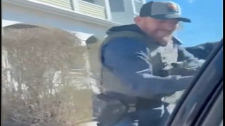 US ICE agents smash car window