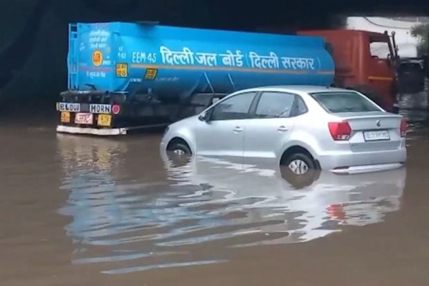 Roads following the Dwarka Flyover underpass faced major waterlogging with passengers stranded and cars half submerged in water. (Image: ANI)