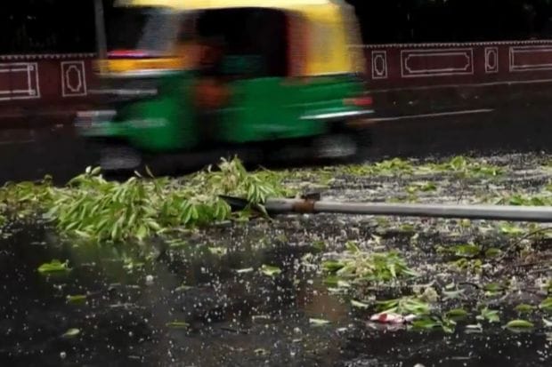 A streetlight got damaged near India Gate as gusty winds ripped through the city before rains started in the night. (Image: PTI)
