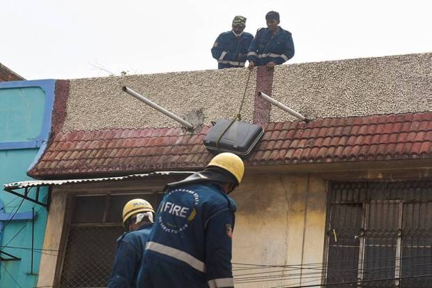 Fire officials are carrying out the rescue operations by climbing up nearby buildings. (Photo source: PTI)