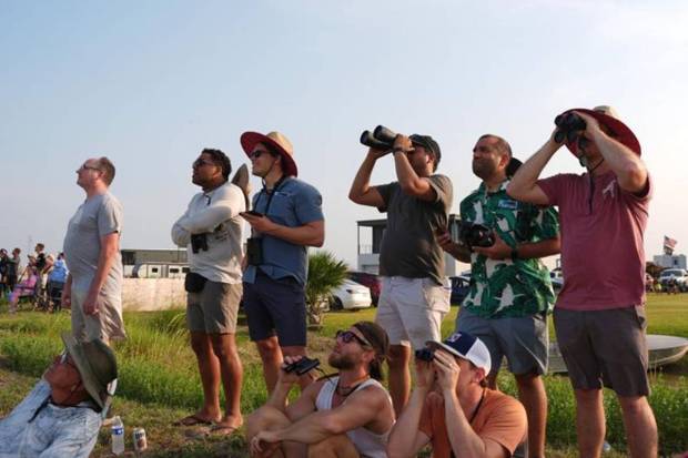 People watch as SpaceX's mega rocket Starship makes a test flight from Starbase. (Photo source: AP)