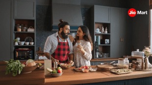 The campaign features four cheeky, slice-of-life films that show the couple navigating relatable kitchen chaos—from “I forgot to buy atta” moments to “late-night ice cream cravings” crises—with JioMart swooping in like a digital superhero
