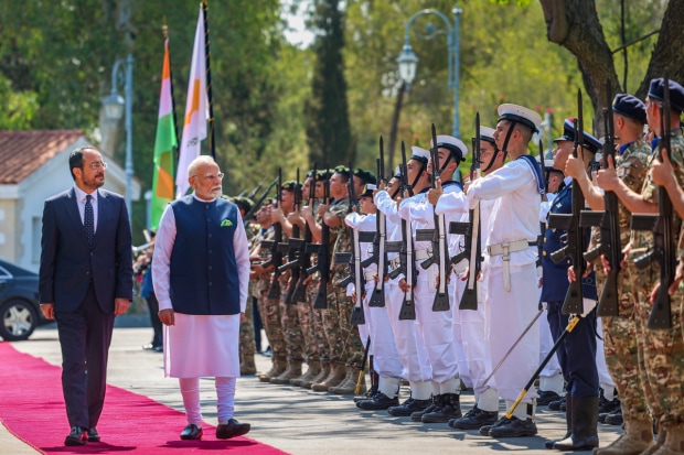 PM Modi, accompanied by a large delegation of around 100 officials, is visiting Cyprus at the invitation of President Nicos Christodoulides.He was received with a ceremonial welcome at Larnaca International Airport by the President. (Photo Source - PTI)