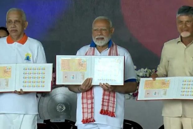 PM Modi along with Andhra Pradesh CM Chandrababu Naidu launched a commemorative postage stamp to mark the 11th International Day of Yoga 2025. (Image: PTI)