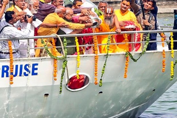 Dilip Das, the head priest of Jagannath Temple, is performing puja of the Sabarmati river with others aboard a river cruise during the Jal Yatra procession of Lord Jagannath in Ahmedabad. (Image Source: PTI)