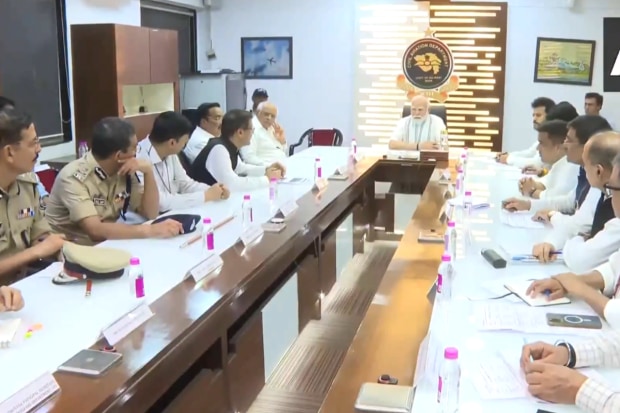 PM Narendra Modi holds review meeting in wake of Ahmedabad plane crash incident. The visuals show PM Modi chairing the meeting while the officials brief him about the accident. (Photo Source - ANI)