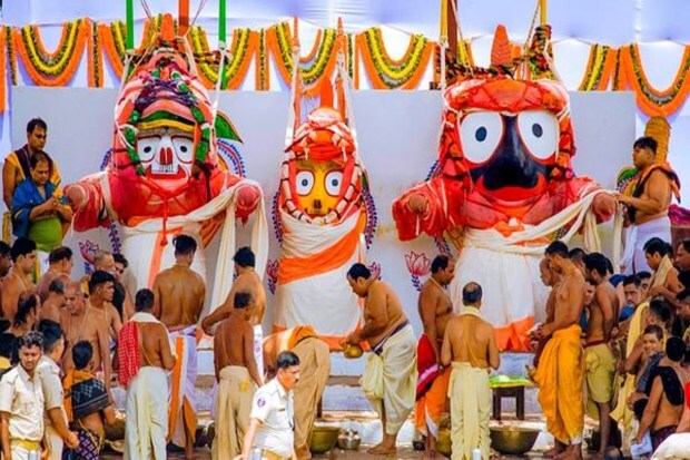Servitors are performing the Snan Purnima rituals for Lord Jagannath, Balabhadra, and Devi Subhadra on the Snan Bedi at the Jagannath Temple. (Image Source: PTI)