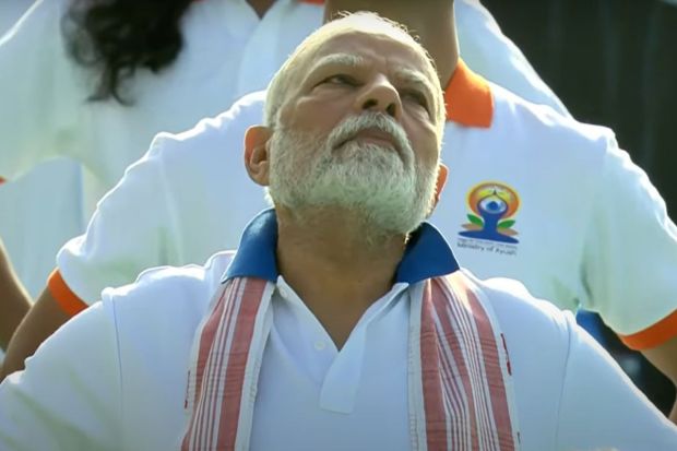 PM Modi, with the crowd attended the celebrations as young minds led the crowd. The celebrations were an hour long with multiple yoga asanas and ended with pranayam. (Image: Screengrab/@BJPGujarat)
