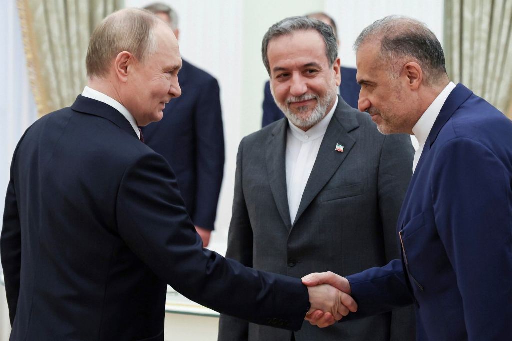 Russian President Vladimir Putin, left, greets Ambassador of Iran to Russia Kazem Jalali, right, and Iranian Foreign Minister Abbas Araghchi, center, prior to their talks at the Kremlin in Moscow (Photo: AP/PTI)