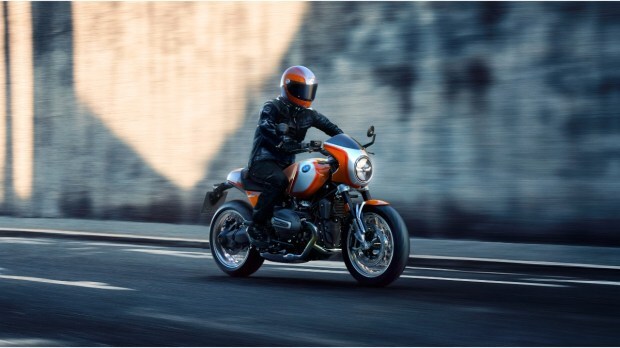 "A motorcycle rider, fully equipped with a helmet, gloves, riding jacket, and knee guards, emphasizing the importance of essential safety gear for bikers and scooter riders