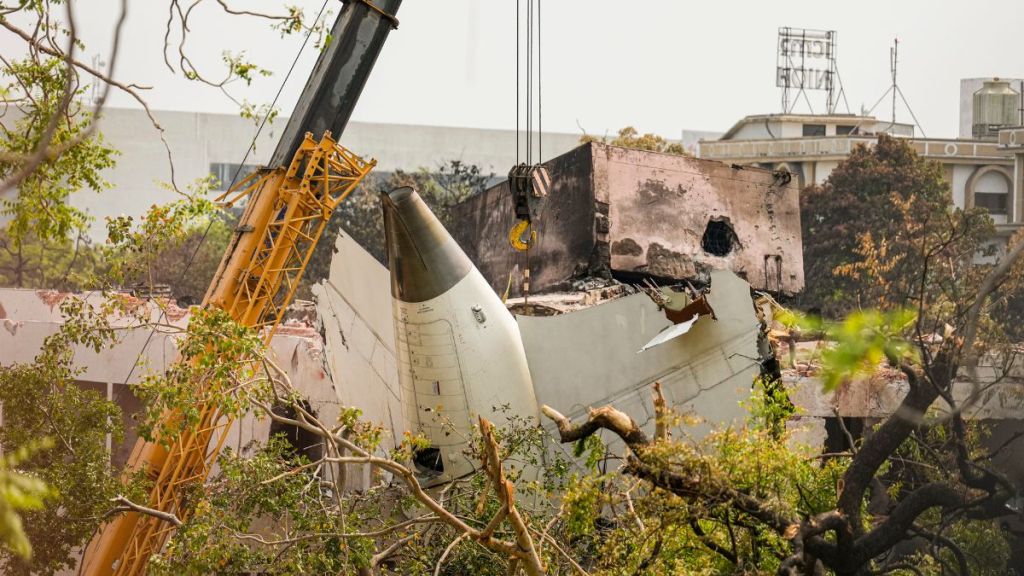 Wreckage of the crashed Air India Boeing 787 plane being lifted through a crane, in Ahmedabad. (Image: PTI)