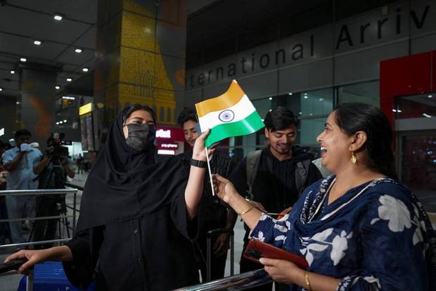 Indian students returning from Iran via Armenia, under an evacuation operation facilitated by the Government of India, react as they exit from the Indira Gandhi International Airport, in New Delhi. (Photo source: PTI)