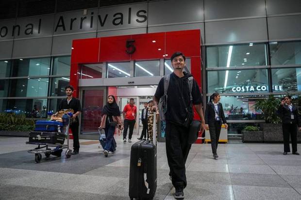 Indian students returning from Iran via Armenia, under an evacuation operation facilitated by the Government of India, react as they exit from the Indira Gandhi International Airport. (Photo source: PTI)