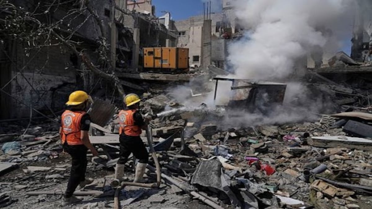 Palestinian firefighters work to extinguish a fire following an Israeli strike that destroyed a building in Deir al-Balah, central Gaza Strip, Monday, June 16, 2025. (Photo: AP/PTI
