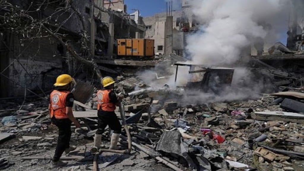Palestinian firefighters work to extinguish a fire following an Israeli strike that destroyed a building in Deir al-Balah, central Gaza Strip, Monday, June 16, 2025. (Photo: AP/PTI Palestinian firefighters work to extinguish a fire following an Israeli strike that destroyed a building in Deir al-Balah, central Gaza Strip, Monday, June 16, 2025. (Photo: AP/PTI