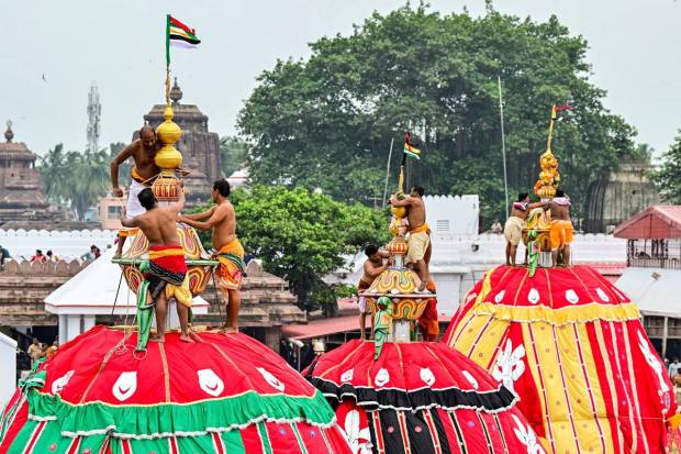 Servitors fix domes over the chariots of Lord Jagannath, Balabhadra, and Devi Subhadra ahead of the Rath Yatra festival, in Puri. (Photo source: PTI)