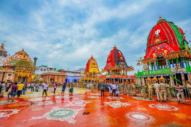 Security personnel keep vigil near the chariots of Lord Jagannath, Lord Balabhadra, and Goddess Subhadra at the Jagannath Temple in Puri, Odisha. (Photo source: PTI)