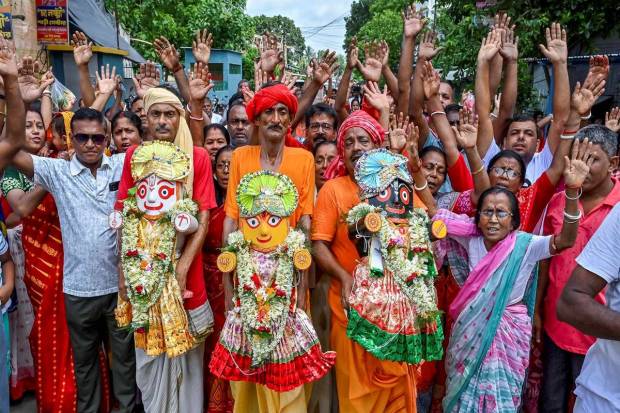 Devotees holding idols of Lord Jagannath, his brother Balabhadra, and sister Subhadra take part in the Rath Yatra procession in Santipur, Nadia district of West Bengal. (Photo source: PTI)
