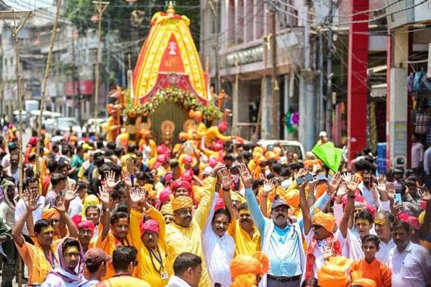 People take part in a procession during the annual Rath Yatra festival, in Prayagraj, on Friday. (Photo source: PTI)