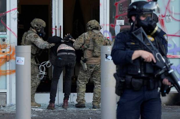 agents detain a man outside the US Immigration and Customs building during a protest Saturday, June 14, 2025, in Portland. (Photo source: AP)
