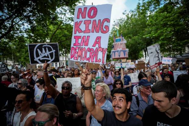 A man holding a banner reading 
