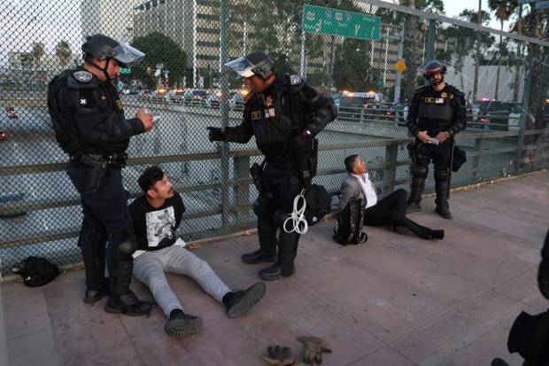 California Highway Patrol officers arrest two men after a dispersal order during a protest Saturday, June 14, 2025, in Los Angeles. (Photo source: AP)