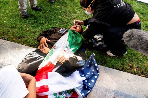 A man receives treatment after being tear-gassed during the protest in Los Angeles. (Photo source: AP)
