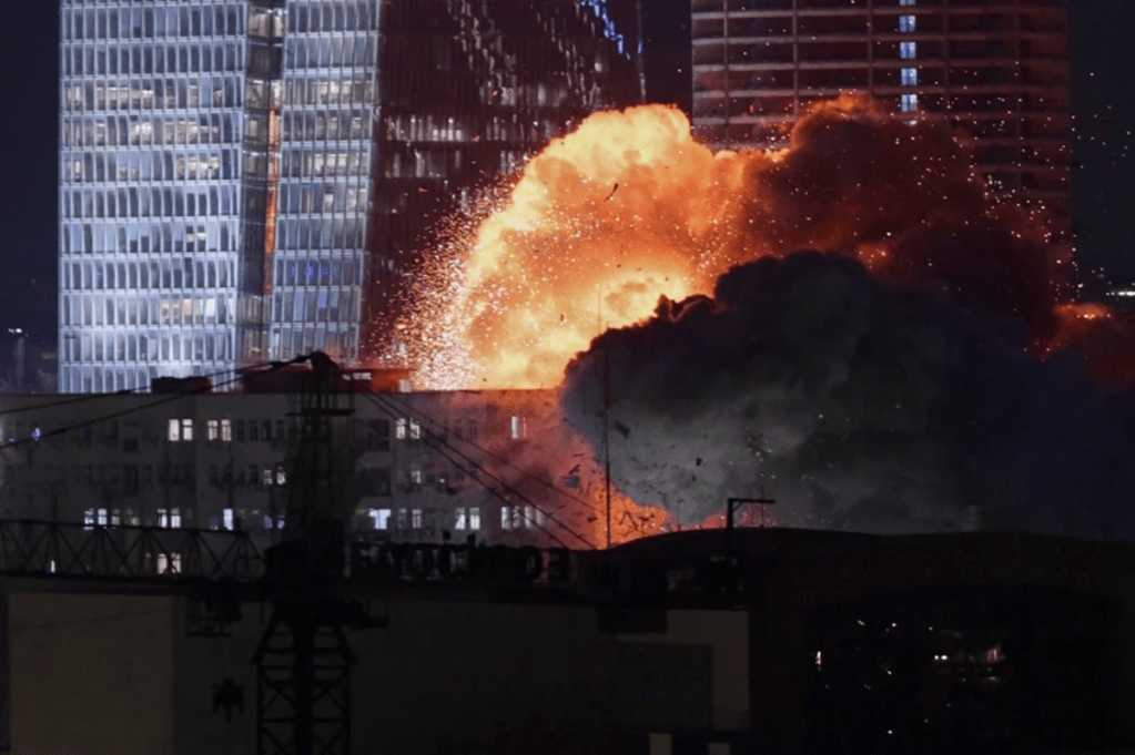 An explosion is seen during a missile attack in Tel Aviv on June 13. (AP Photo)