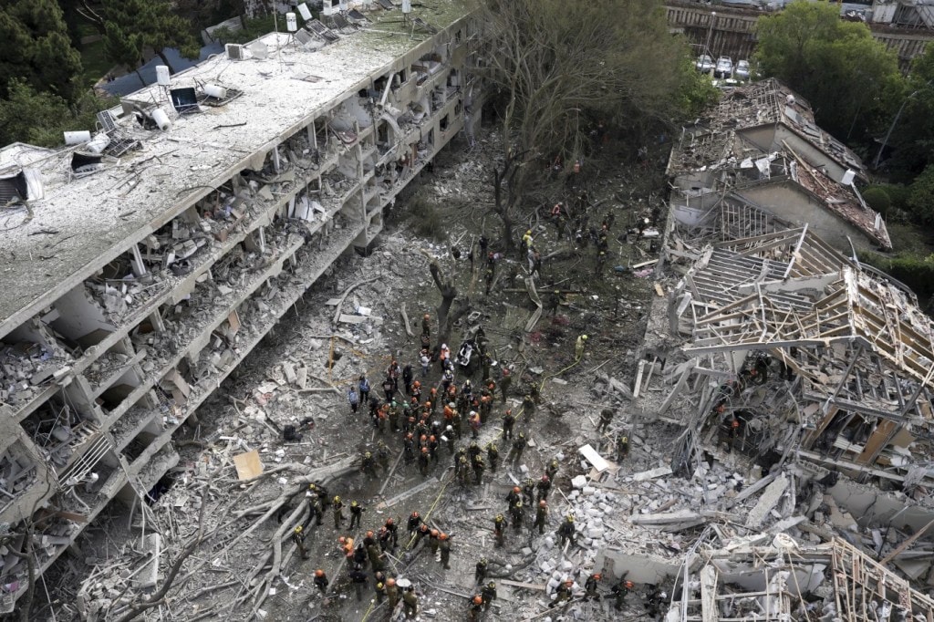 Rescue workers and firefighters survey the site of a direct missile strike launched from Iran in Tel Aviv (Photo: AP)