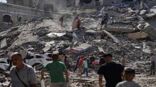 Palestinians inspect the damage after an Israeli strike on a residential building in Gaza City, Friday, June 27, 2025. (AP Photo/Jehad Alshrafi)