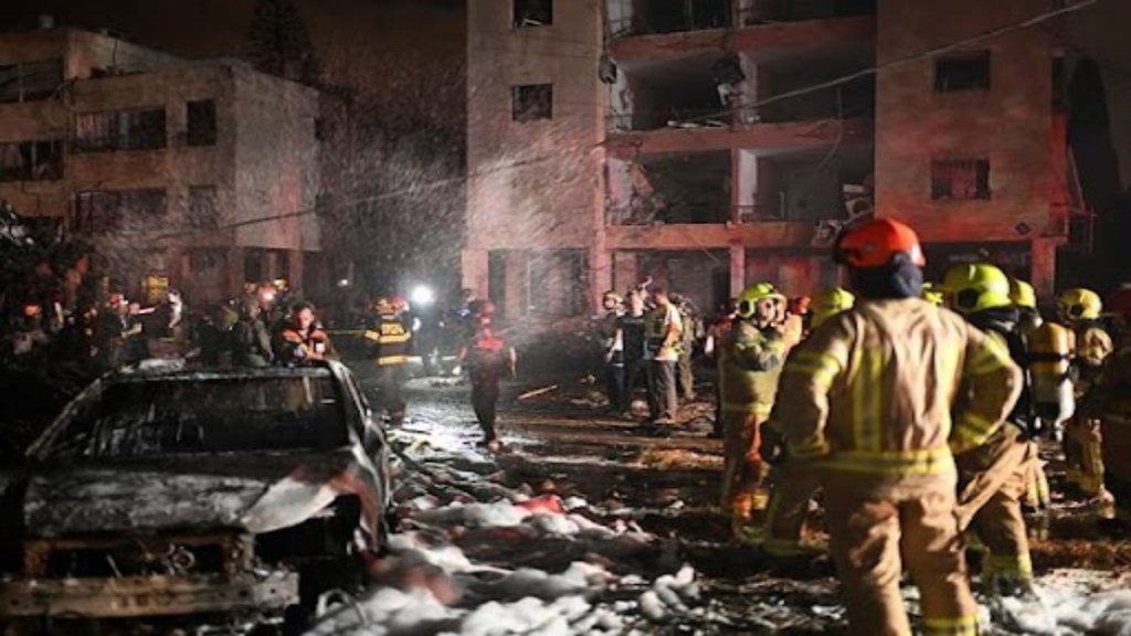 Firefighters work at a site struck by a missile launched from Iran, in Haifa, northern Israel, on Sunday, June 15, 2025. (AP Photo/Rami Shlush)