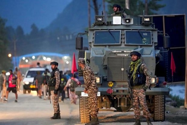 Security personnel are on guard as the initial group of pilgrims departs from the Nunwan base camp in Pahalgam for the annual Amarnath Yatra. (Image Source: PTI)