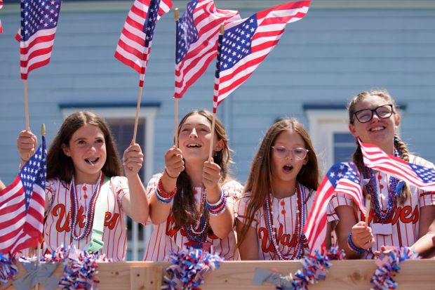 Members of the Waves softball team take part in The Half Moon Ol' Fashioned 4th of July Parade in California. (Image: AP)