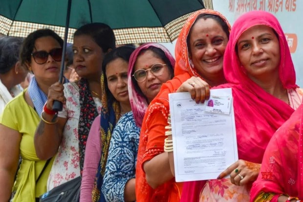 Devotees are seen waiting in queues at the Amarnath Yatra Registration Centre at Yatri Niwas, Pantha Chowk, in Srinagar on Wednesday, July 2. (Image Source: IANS)