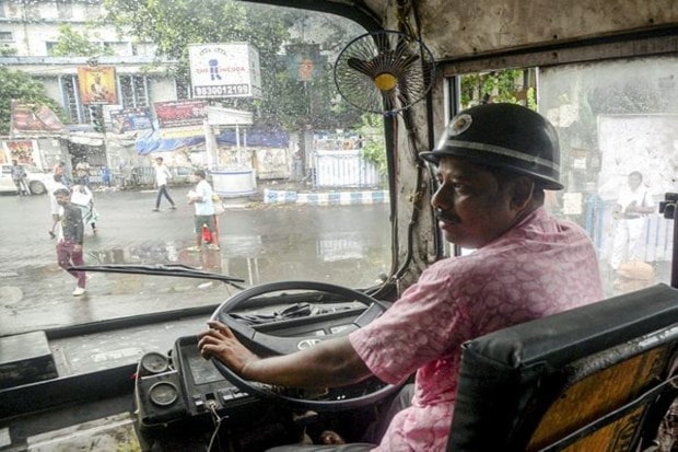 In Kolkata on Wednesday, a bus driver wore a helmet during the 'Bharat Bandh' (nationwide general strike) called by central trade unions against the government's 