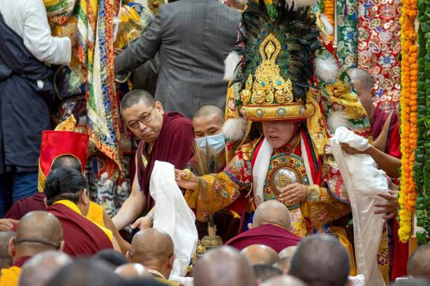Nechung oracle, in his ceremonial costume, goes into trance in a hall where the Tibetan spiritual leader, the Dalai Lama, unseen, presided over an event during which Tibetan exiles prayed for the Tibetan leader's longevity, a day before his 90th birthday, in Dharamshala, India. (Photo source: AP)
