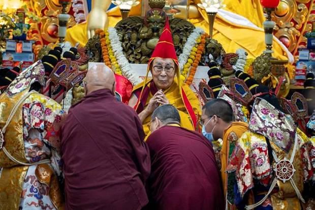 Tibetan spiritual leader, the Dalai Lama, wears a ceremonial hat as he presides over an event. (Photo source: AP)