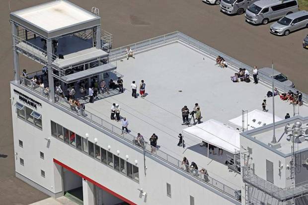 People take shelter on the roof of a fire station in Mukawa town, Hokkaido, northern Japan, Wednesday, July 30, 2025, after a powerful earthquake in Russia's Far East prompted a tsunami alert in parts of Japan. (Photo source: AP)