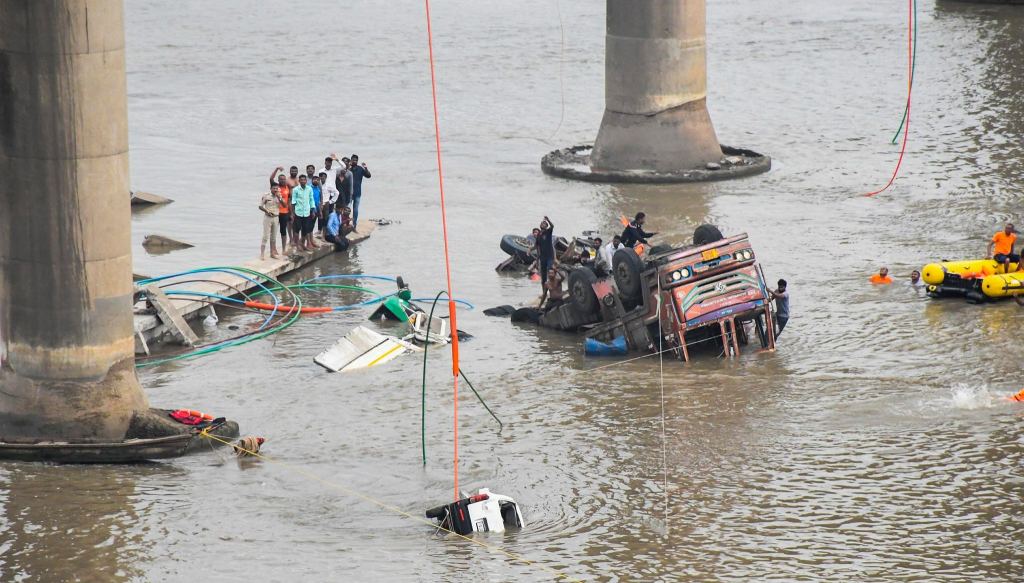 Rescue operation underway after several vehicles fell into the Mahisagar river when a portion of a four-decade-old bridge collapsed (Photo: PTI) Rescue operation underway after several vehicles fell into the Mahisagar river when a portion of a four-decade-old bridge collapsed (Photo: PTI)