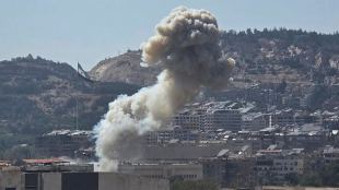 Smoke rises from an Israeli airstrike that hit the Syrian Defence Ministry (SANA via AP)