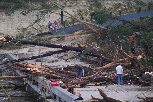 Debris rests on a bridge over the Guadalupe River.