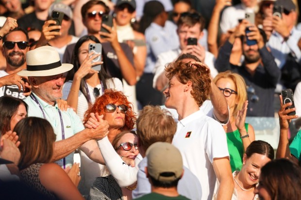 Jannik Sinner celebrates with the crowd following his victory over Carlos Alcaraz in the men’s singles final at Wimbledon in London. (Photo: AP/Kirsty Wigglesworth)
