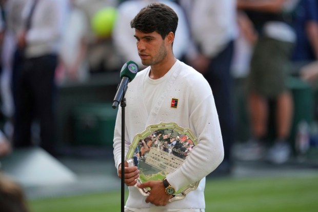 Carlos Alcaraz of Spain is interviewed holding his runners-up trophy after losing to Italy's Jannik Sinner in the men's singles final at the Wimbledon Tennis Championships. (Photo: AP)