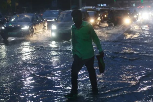 Commuters navigate flooded streets in Mumbai as torrential rains cause major traffic snarls. (Express Photo)