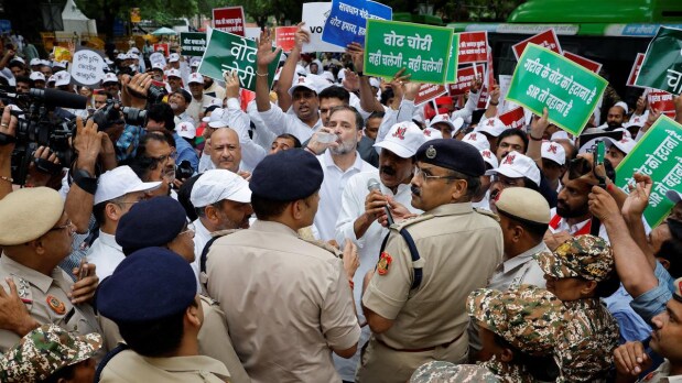 INDIA alliance MPs, including Leaders of Opposition Rahul Gandhi and Mallikarjun Kharge, took out a protest march on Monday (August 11, 2025) from Parliament House to the Election Commission against the Special Intensive Revision (SIR) of electoral rolls in Bihar and alleged “vote chori” but were stopped midway by the police and detained citing disruption. Police put up barricades on the way to prevent the MPs, protesting the voter roll revision in Bihar and the alleged poll rigging, from marching forward. (Photo Source: Official Twitter handle @INCIndia)