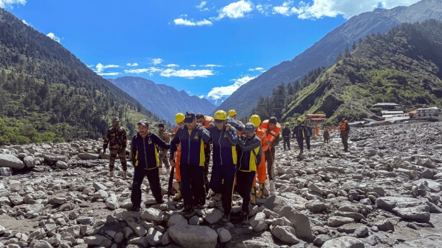 Rescue personnel from the Indian Army and SDRF prepare for deployment amid intense weather warnings. Coordination among these forces exemplified the multi-agency effort to reach the hardest-hit areas in Uttarakashi. (Photo Source: PTI)